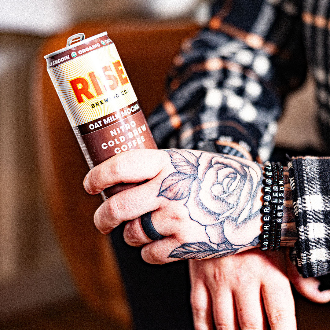 RISE Brewing Co. Oat Milk Mocha Nitro Cold Brew 7oz tattoo hand