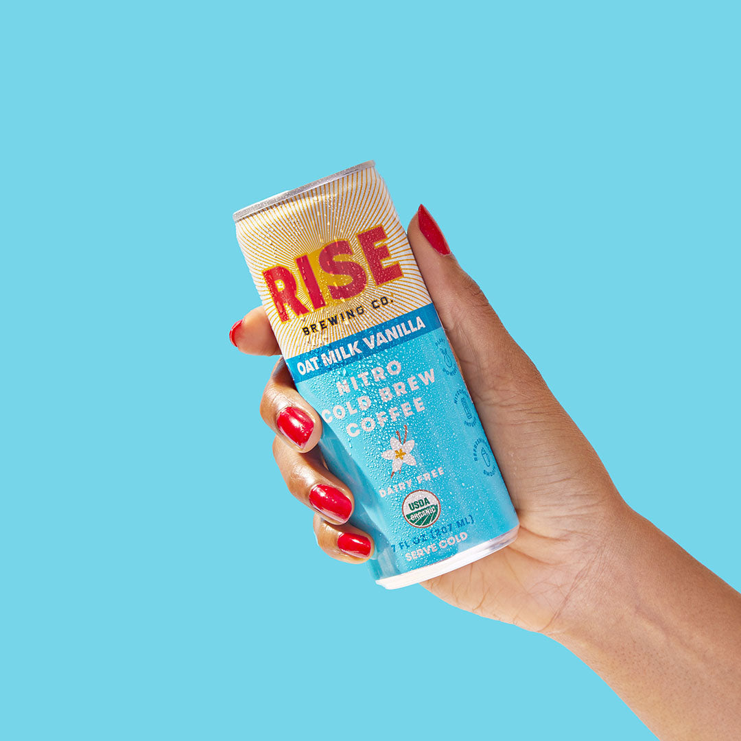 RISE Brewing Co. Oat Milk Vanilla Latte Cold Brew hand