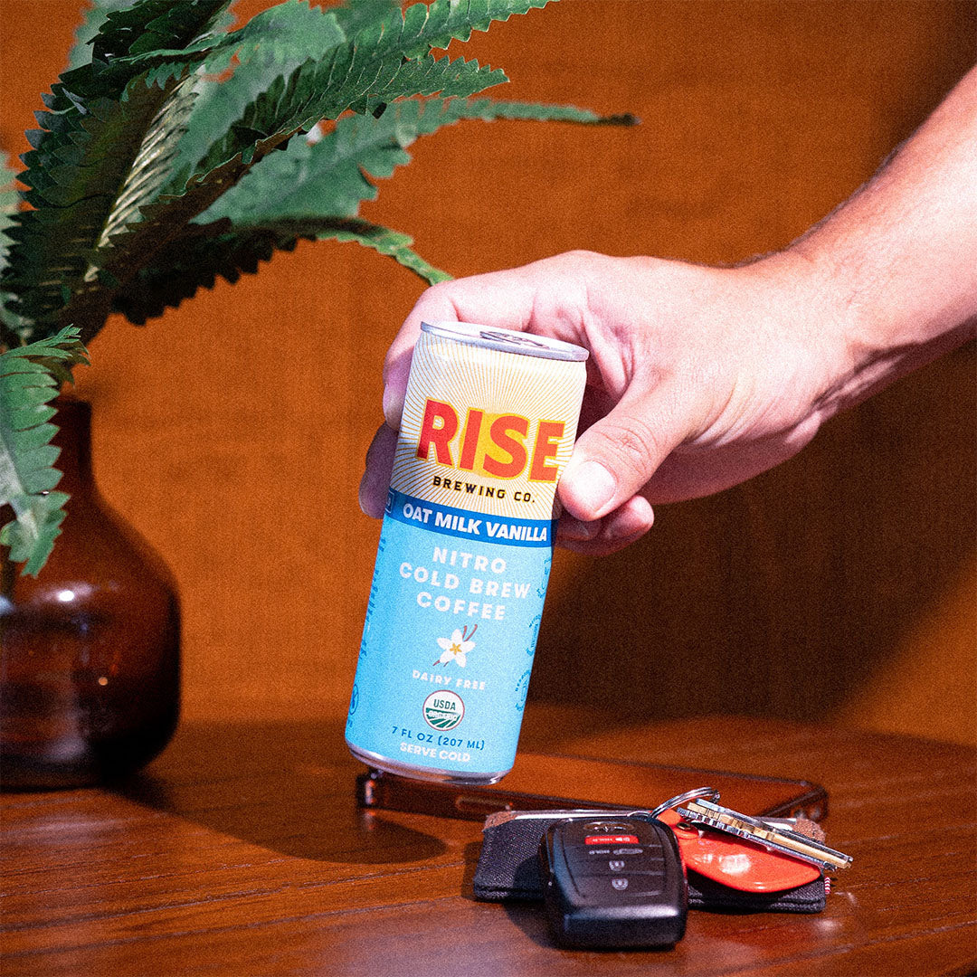 RISE Brewing Co. Oat Milk Vanilla Latte Cold Brew phone and keys