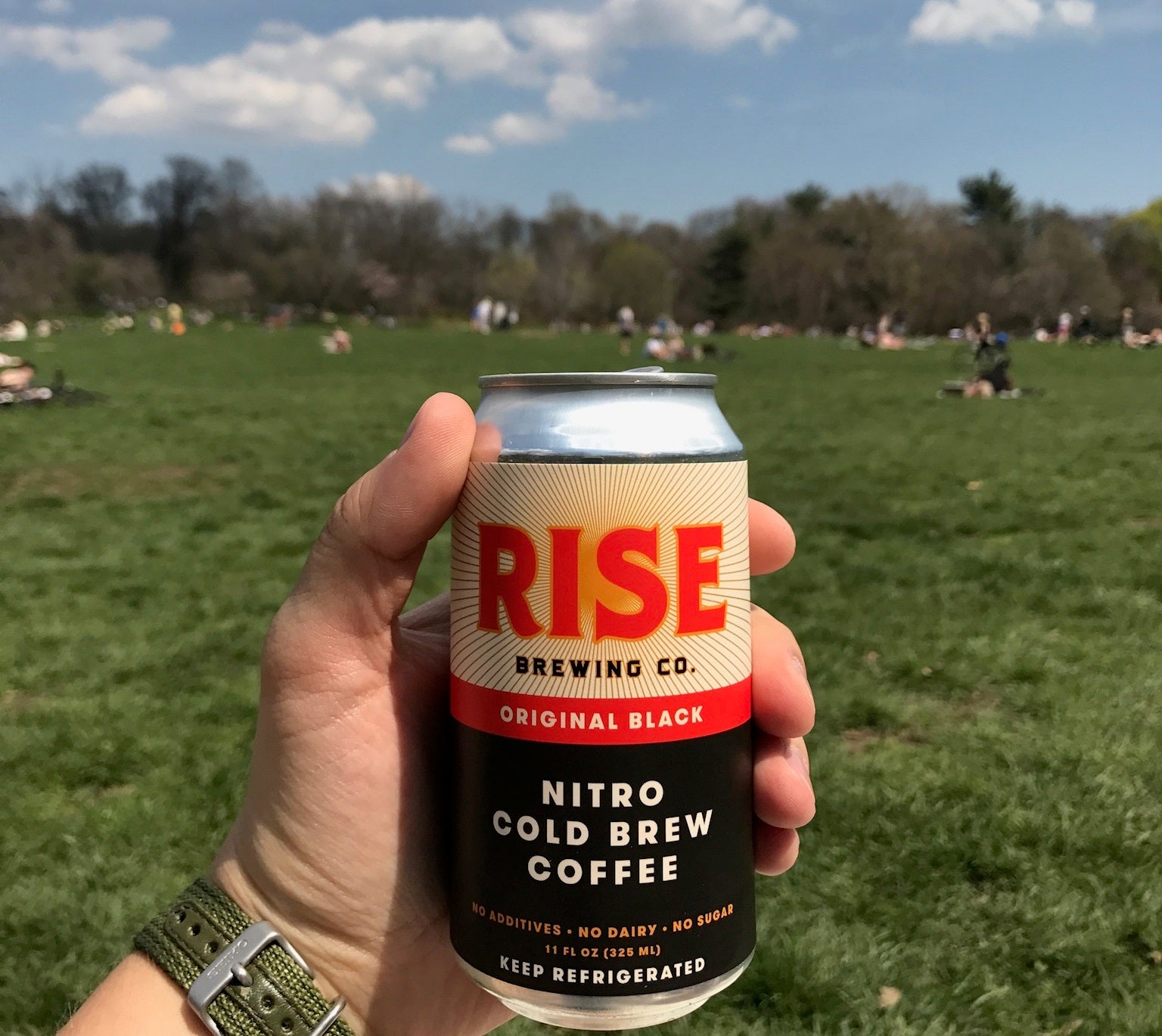 RISE Brewing Co nitro cold brew coffee Original Black in a can in the park for exercise and recreation