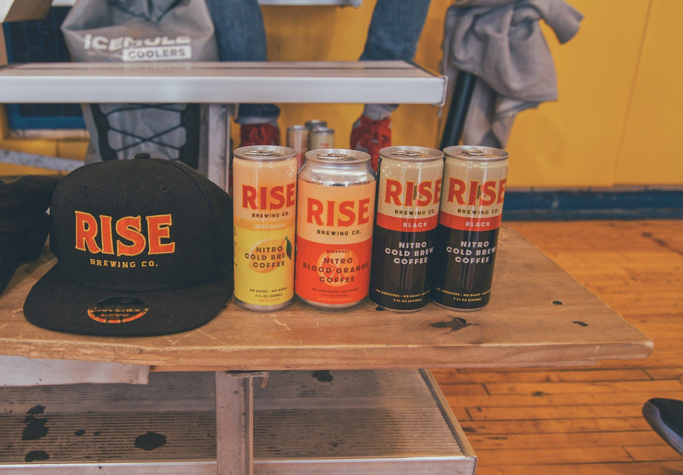 RISE Nitro Cold Brew Coffee in Original Black, Lemonade, and Blood Orange Flavors; RISE Brewing Co. hat | RISE Coffee