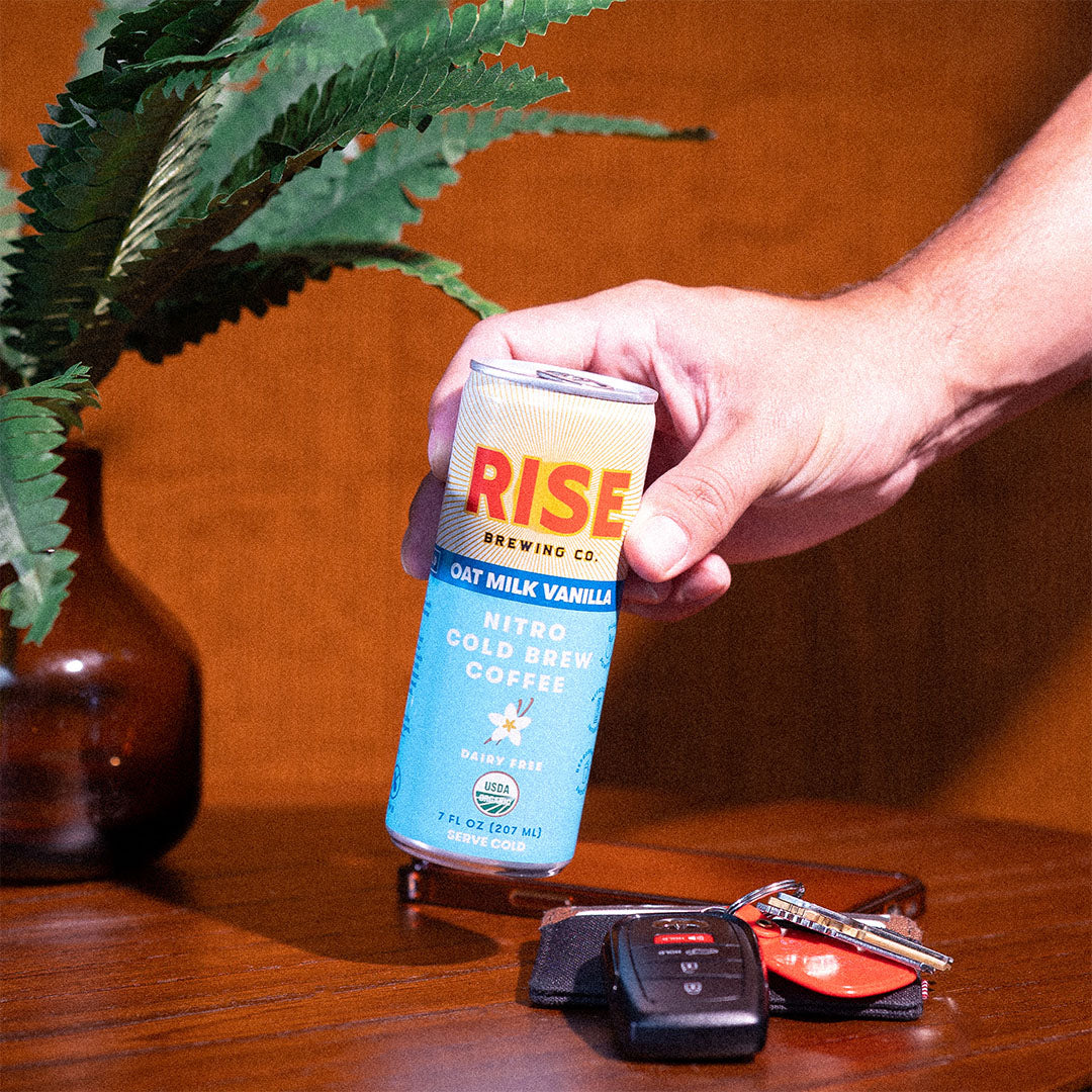 RISE Brewing Co. Oat Milk Vanilla Latte Cold Brew phone and keys 